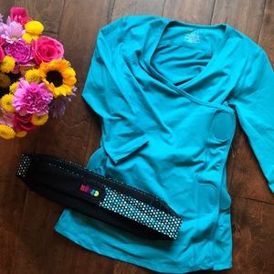 Nuroo baby holding shirt.  Never used